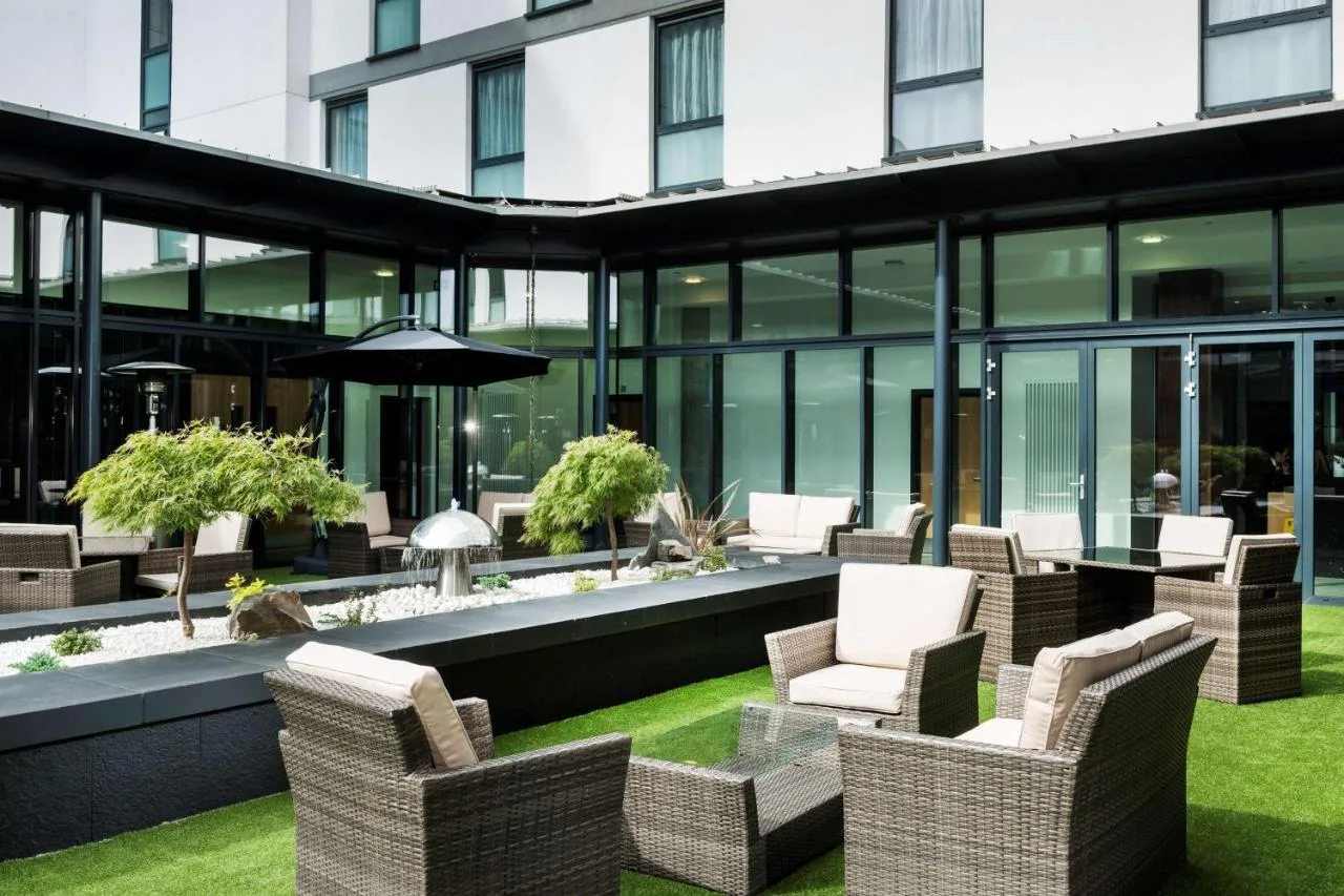 A patio with chairs and tables at Park Inn by Radisson Aberdeen on Justice Mill Lane