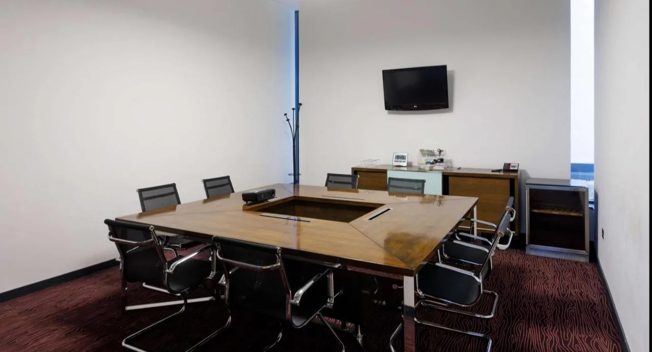 A larger conference room set up with wooden chairs