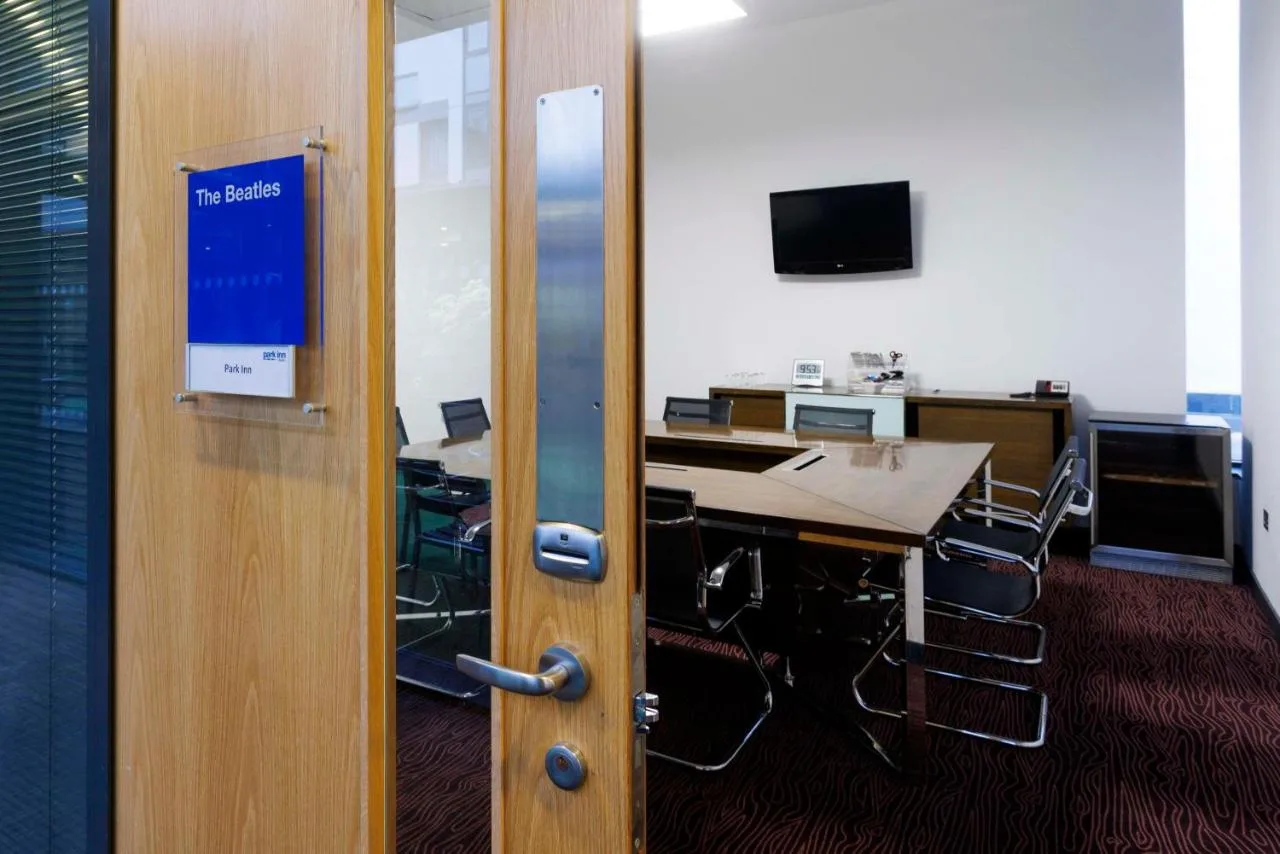An office space with a desk and meeting table
